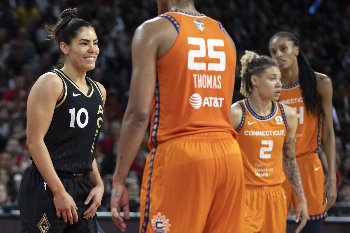 Las Vegas Aces guard Kelsey Plum (10) smiles at her team after scoring while Connecticut Sun fo ...