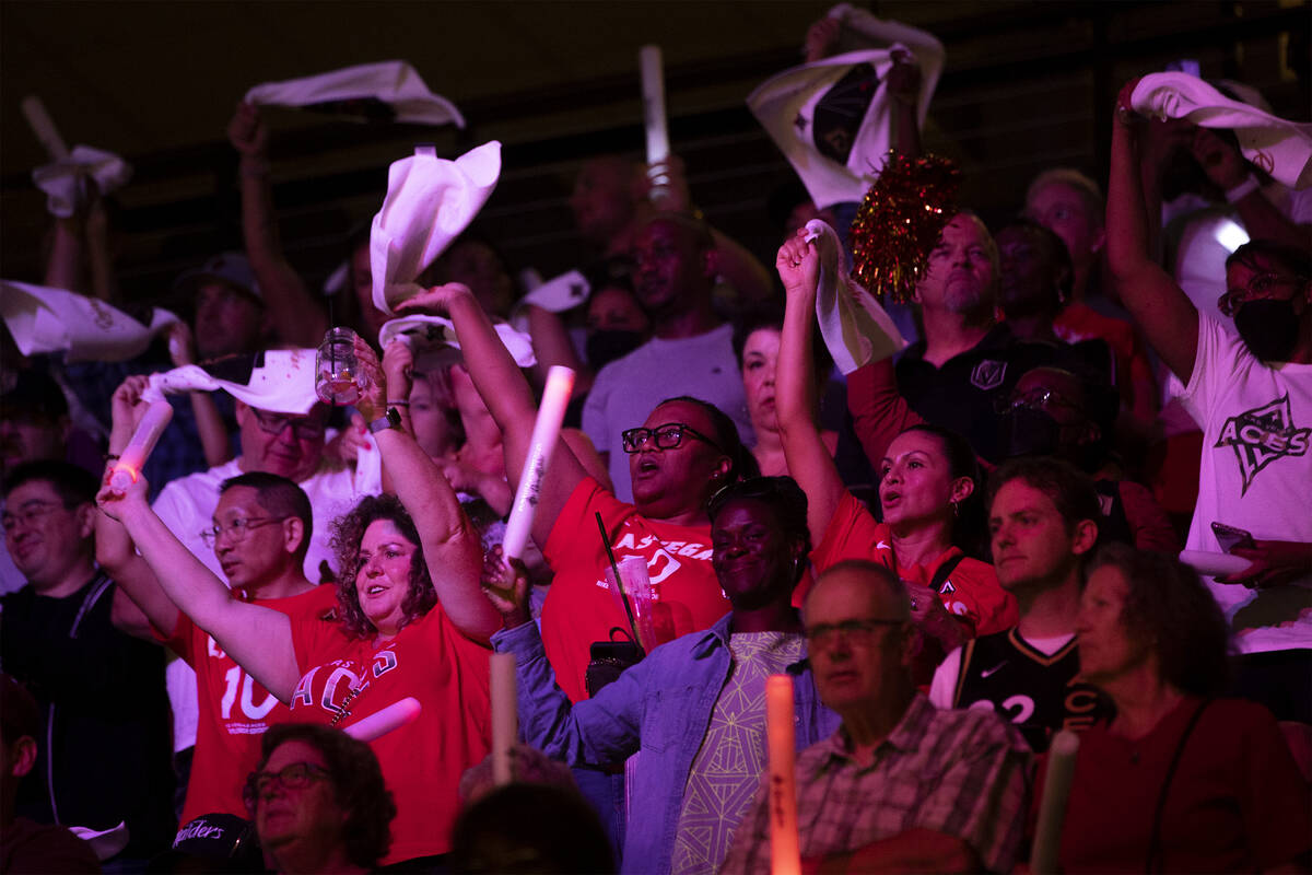 Las Vegas Aces fans wave their team towels during the second half in Game 1 of a WNBA basketbal ...