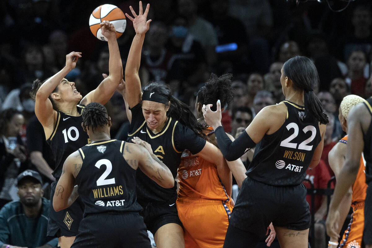 Las Vegas Aces guard Kelsey Plum (10) and forward Dearica Hamby (5) jump to gain the rebound ag ...
