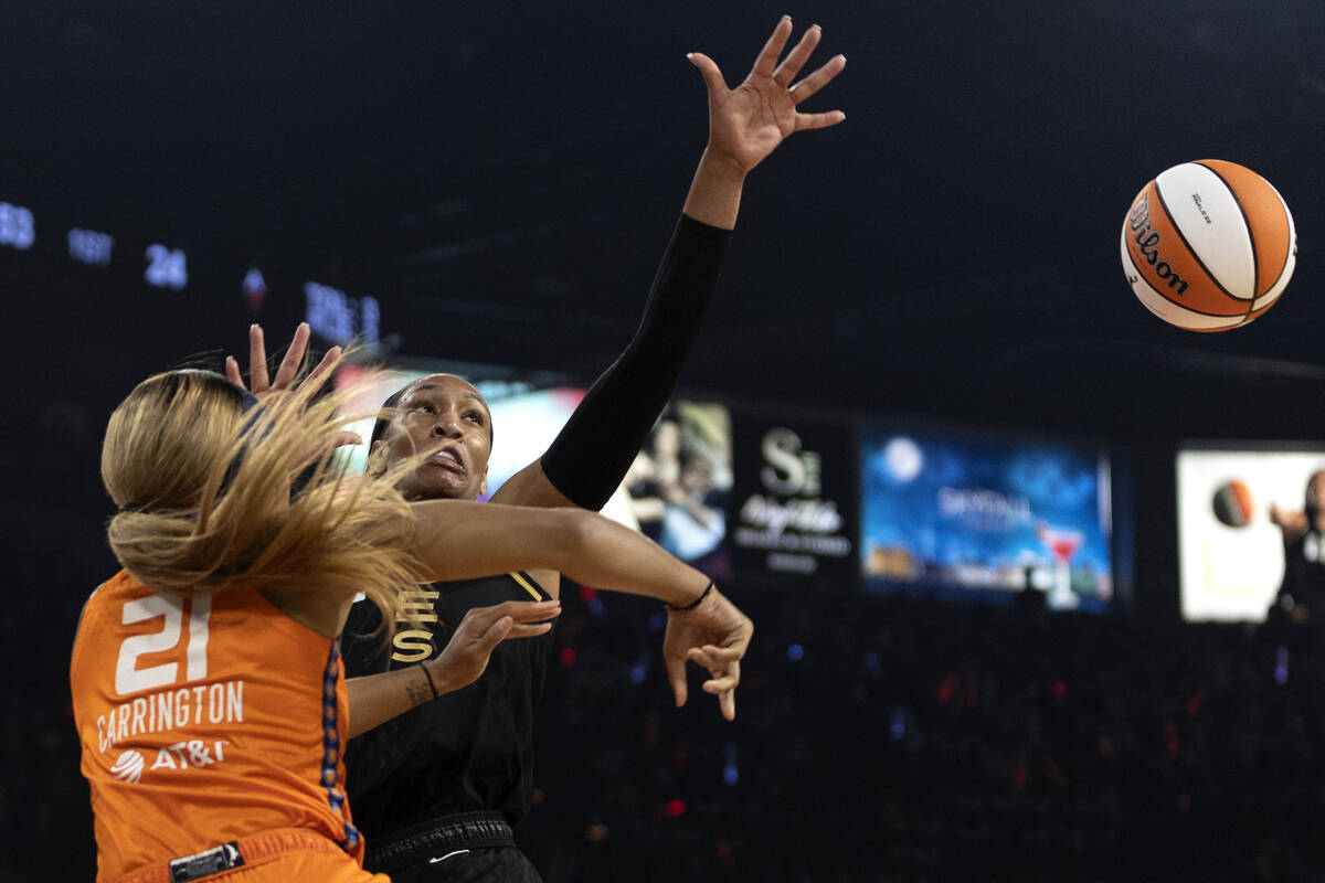 Las Vegas Aces forward A'ja Wilson (22) knocks the ball away from Connecticut Sun guard DiJonai ...