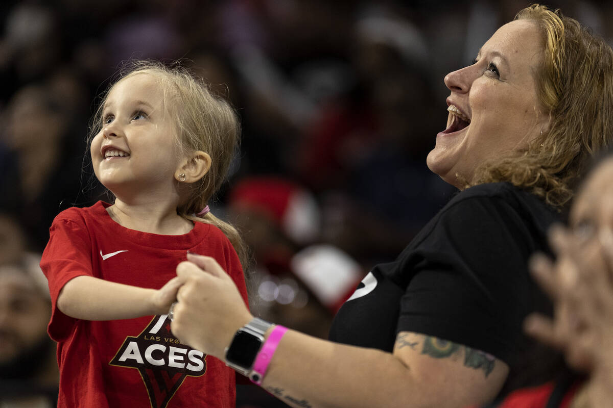 Las Vegas Aces fans Leigh Horvath, 3, left, and her mom Ashley Horvath dance for the A'ja Wilso ...