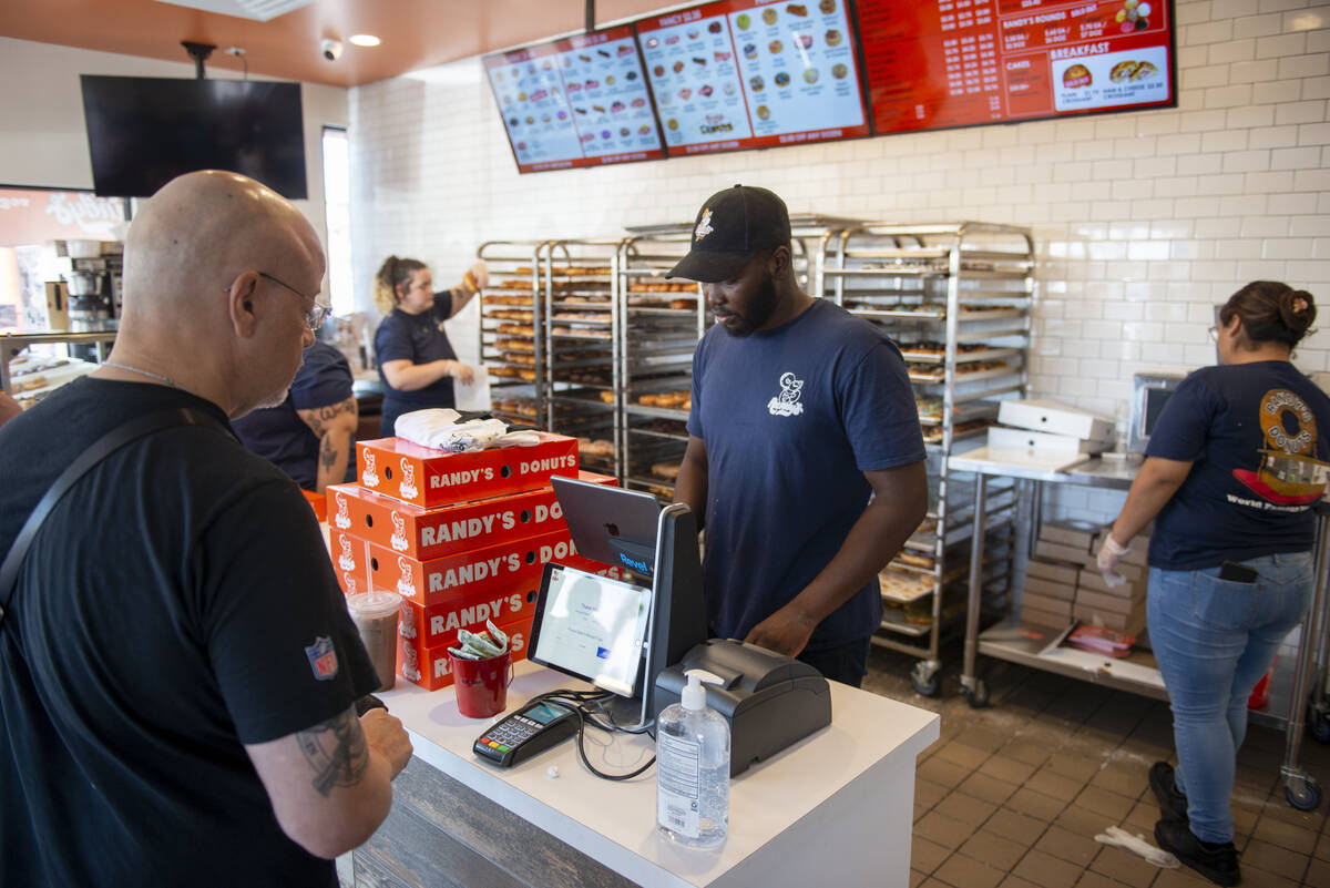 Daniel Ramadji serves customers at Randy's Donuts on South Rainbow Boulevard on Friday, Aug. 19 ...