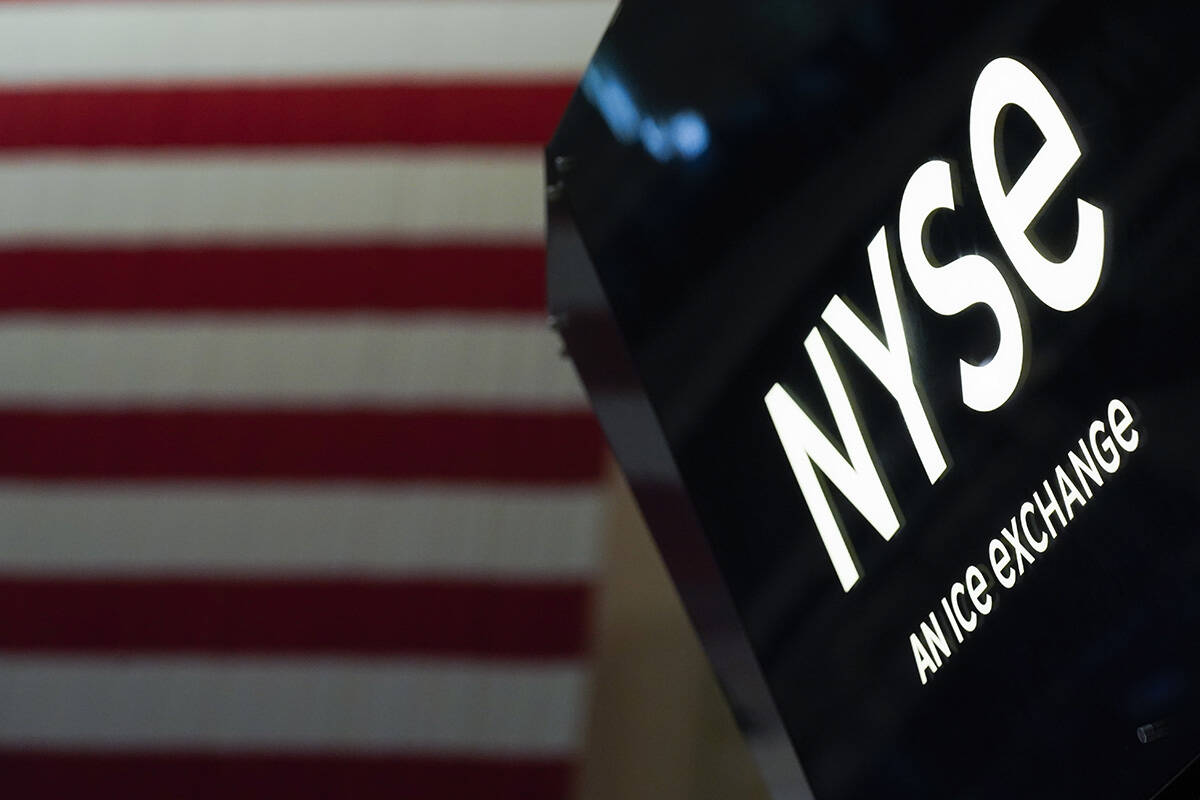 FILE - An NYSE sign is seen on the floor at the New York Stock Exchange in New York, on June 15 ...