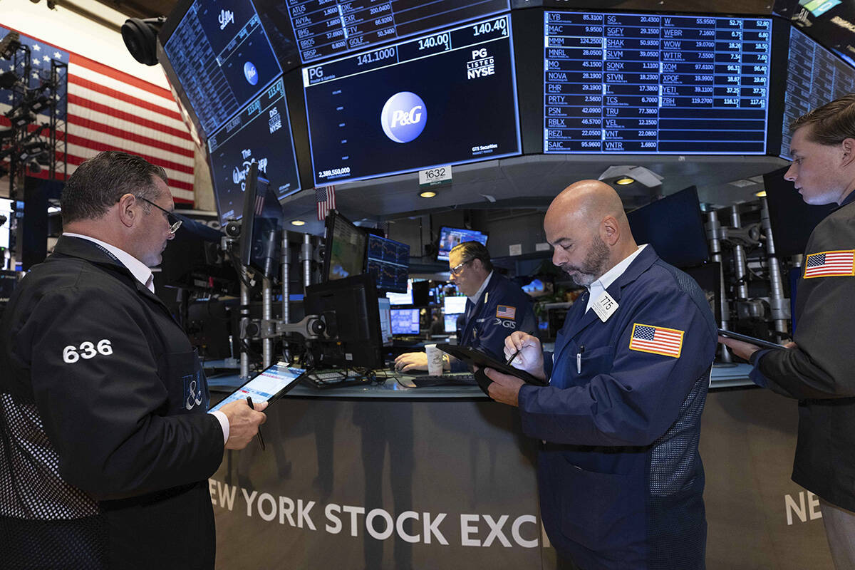 In this photo provided by the New York Stock Exchange, traders work on the floor of the exchang ...