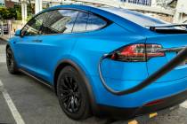 A car is plugged in at the Tesla Supercharger station near The LINQ and High Roller on Friday, ...