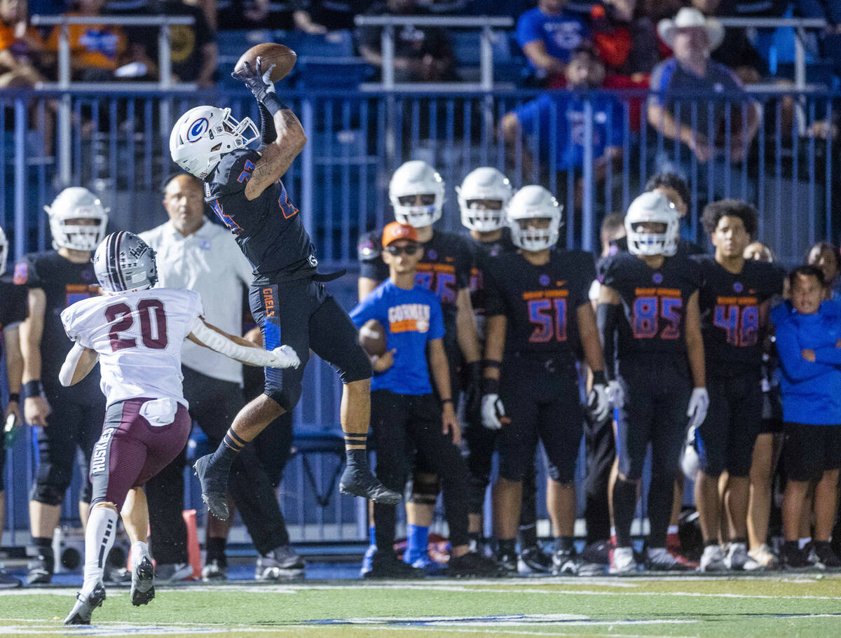 Bishop Gorman wide receiver Trech Kekahuna (23) leaps for a long reception over Hamilton corner ...
