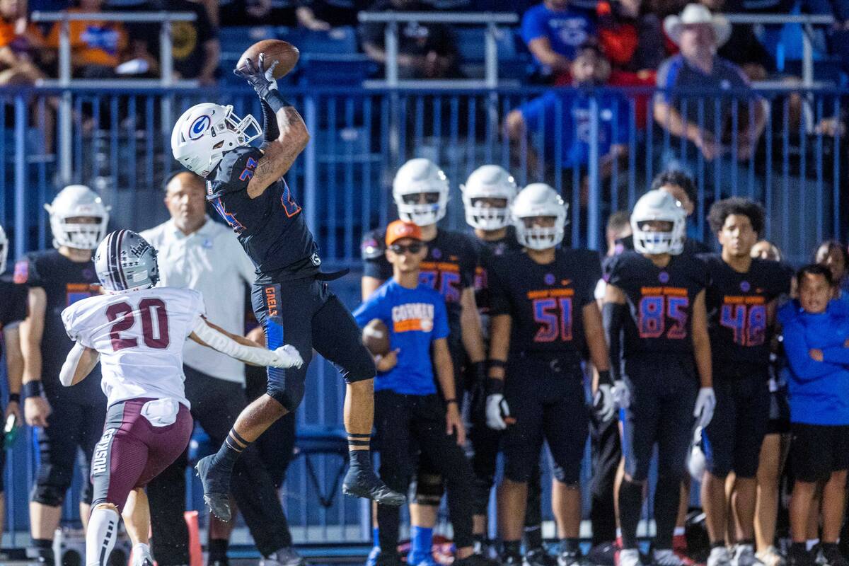 Bishop Gorman wide receiver Trech Kekahuna (23) leaps for a long reception over Hamilton corner ...