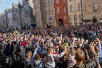 People attend the procession of Queen Elizabeth II's coffin, from the Palace of Holyroodhouse t ...