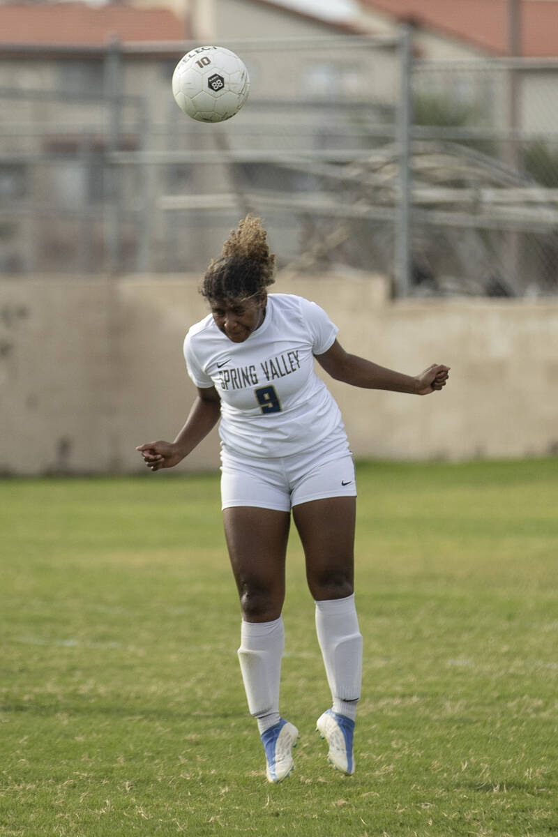 Spring Valley High School’s Jeanie Tuku (9) heads the ball during their game against Val ...
