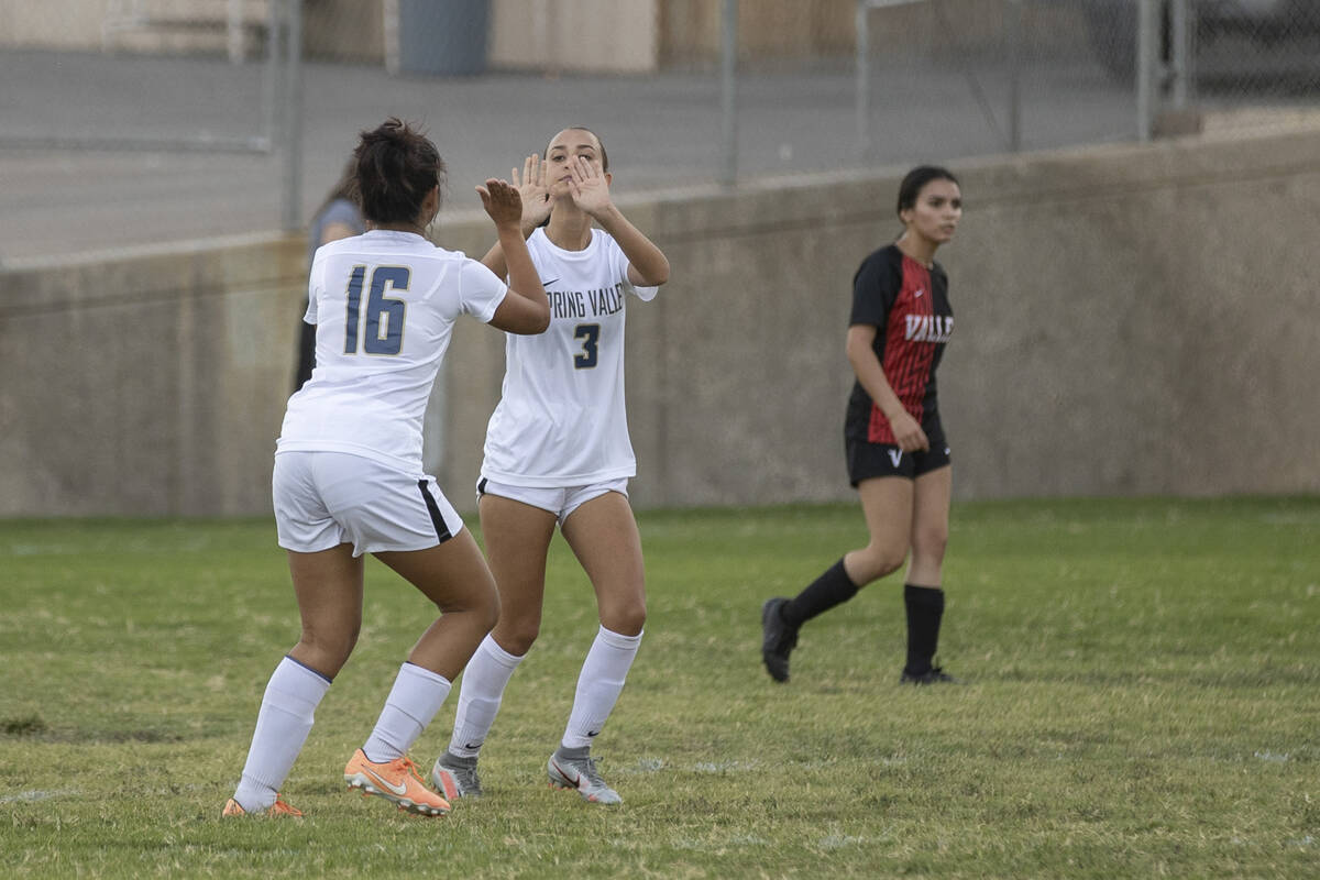 Spring Valley High School's Fatima Navarro (16) and Tyra Nelson (3) celebrate Nelson's goal in ...