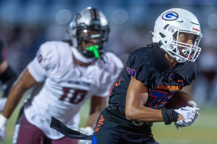 Bishop Gorman running back Myles Norman (34) heads towards the end zone over a Hamilton defende ...