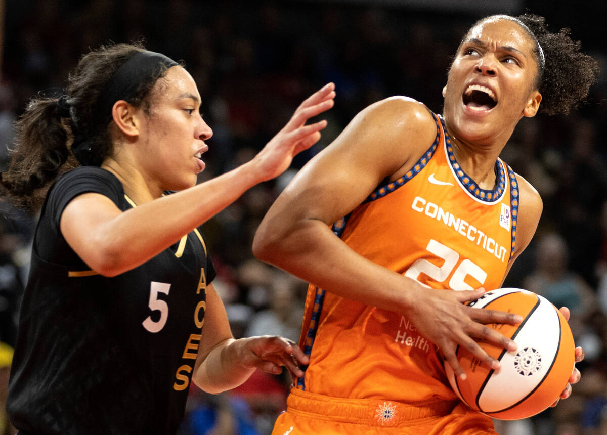 Connecticut Sun forward Alyssa Thomas (25) drives around Las Vegas Aces forward Dearica Hamby ( ...
