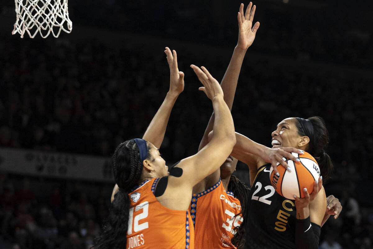 Las Vegas Aces forward A'ja Wilson (22) shoots against Connecticut Sun center Brionna Jones (42 ...