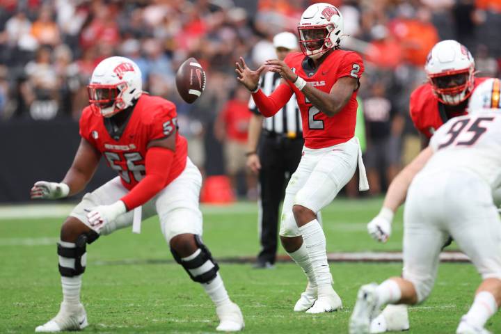 UNLV quarterback Doug Brumfield (2) reaches for a snapped ball during the first half of a NCAA ...