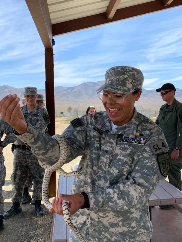 Las Vegas 17-year-old Esmeralda Bueno holds a snake during an activity through Battle Born Yout ...