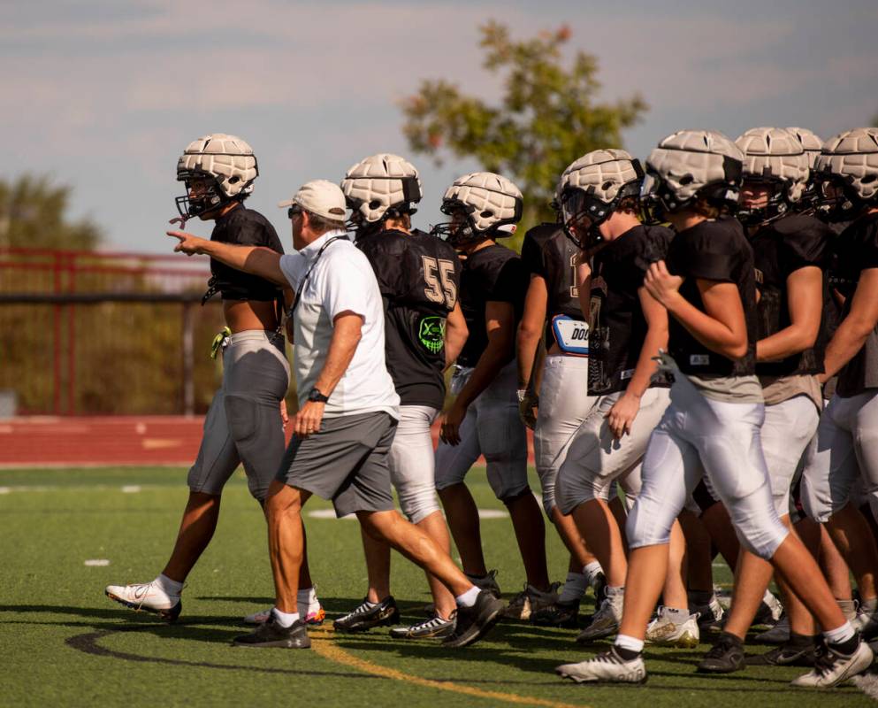 Former UNLV coach, and Faith Lutheran head coach, Mike Sanford leads a drill during practice at ...
