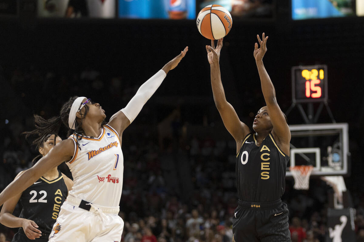Las Vegas Aces guard Jackie Young (0) shoots against Phoenix Mercury guard Diamond DeShields (1 ...