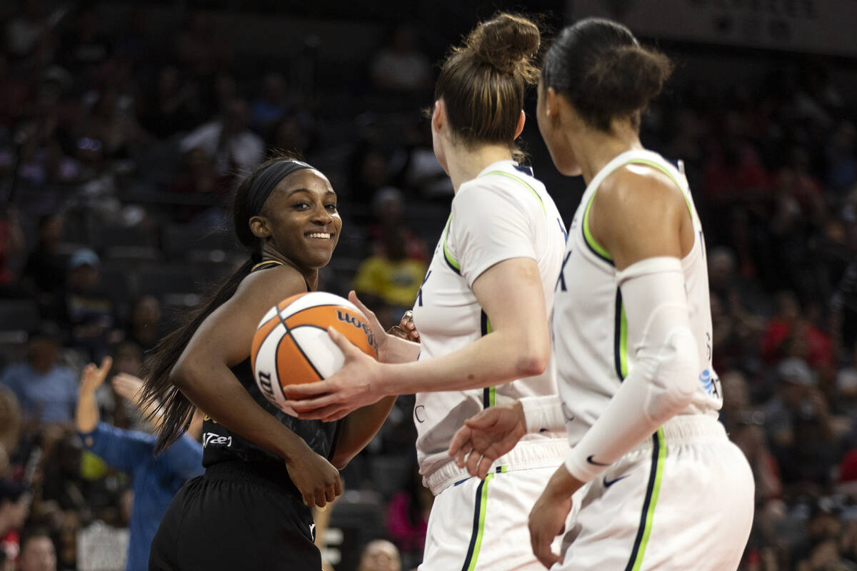 Las Vegas Aces guard Jackie Young (0) smiles after scoring at Minnesota Lynx forward Jessica Sh ...