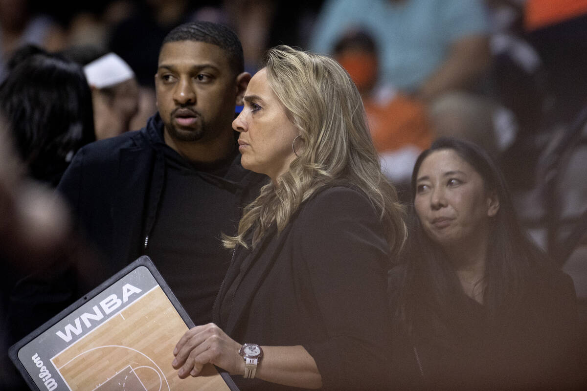 Las Vegas Aces head coach Becky Hammon, flanked by assistant coach/head of player development T ...