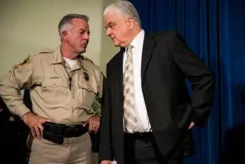 Clark County Sheriff Joe Lombardo, left, and then-County Commissioner Steve Sisolak during a ne ...