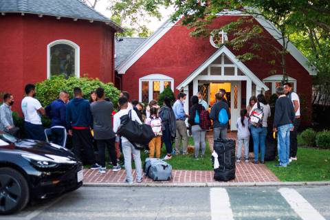 Immigrants gather with their belongings outside St. Andrews Episcopal Church, Wednesday Sept. 1 ...