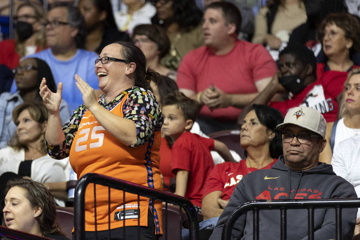 A Connecticut Sun fan cheers while a Las Vegas Aces fan frowns during the second half in Game 3 ...