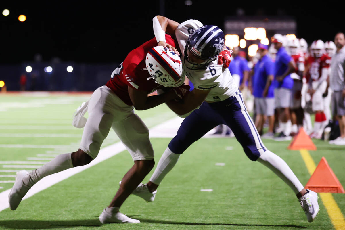 Kamehameha Kapalama's quarterback (6) is pushed out out of bounds by Liberty's Sampson Alofipo ...