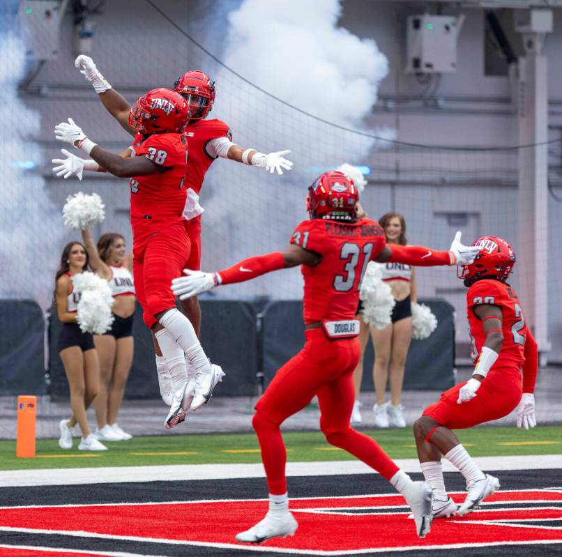 UNLV Rebels defensive back Cameron Oliver (5) and UNLV Rebels linebacker Marsel McDuffie (38) c ...