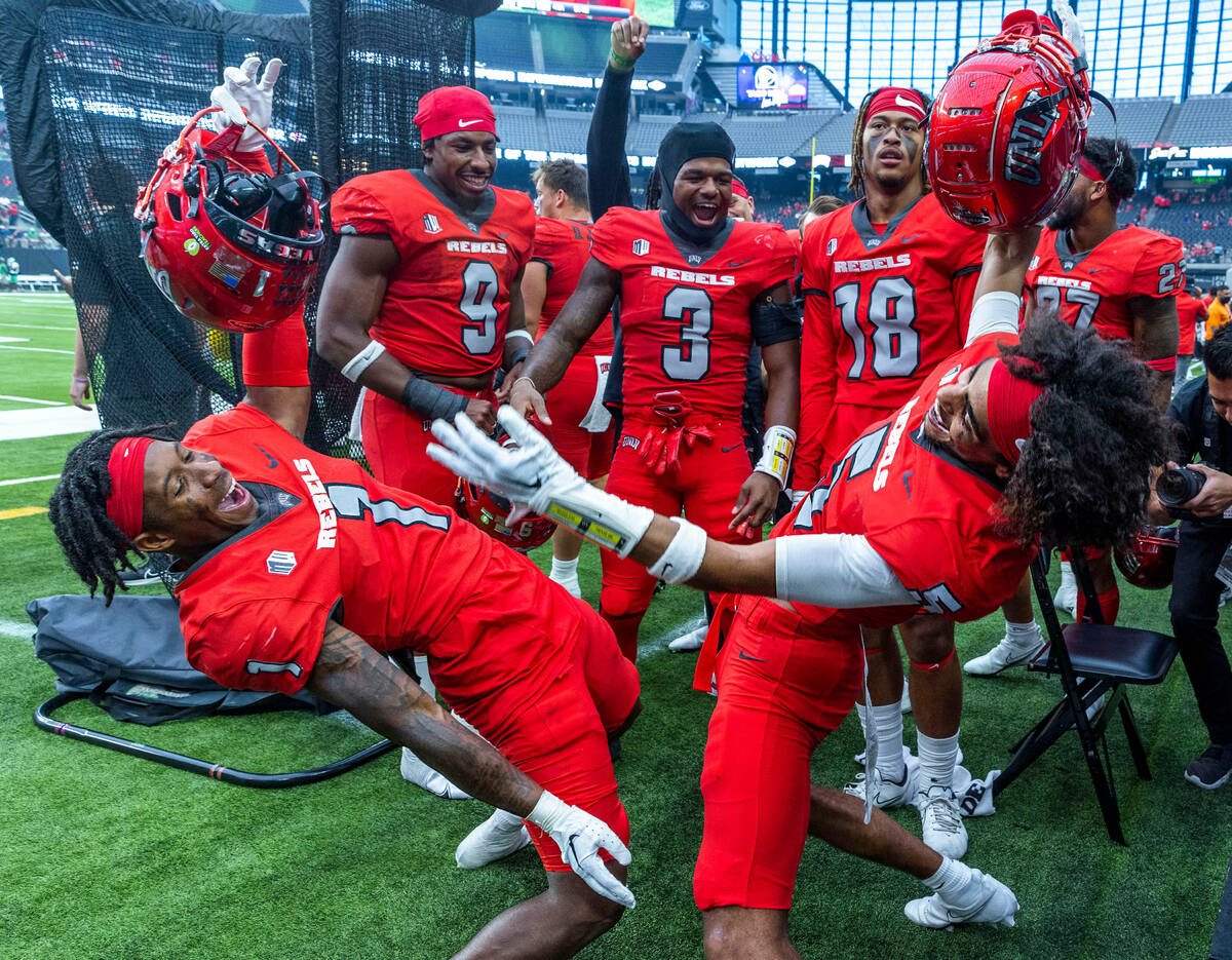 UNLV Rebels wide receiver Kyle Williams (1) and defensive back Cameron Oliver (5) celebrate ano ...