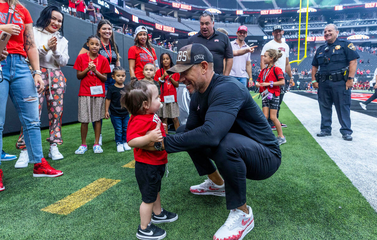 UNLV Rebels head coach Marcus Arroyo greets his daughter Cruz following their win over the Nort ...