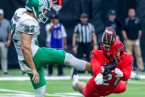 UNLV Rebels defensive back BJ Harris (21) takes a cleat to the chin while blocking a kick by No ...