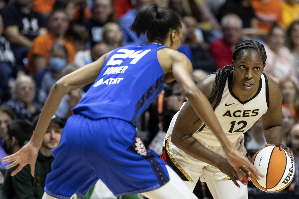Las Vegas Aces guard Chelsea Gray (12) looks for an opening while Connecticut Sun forward DeWan ...