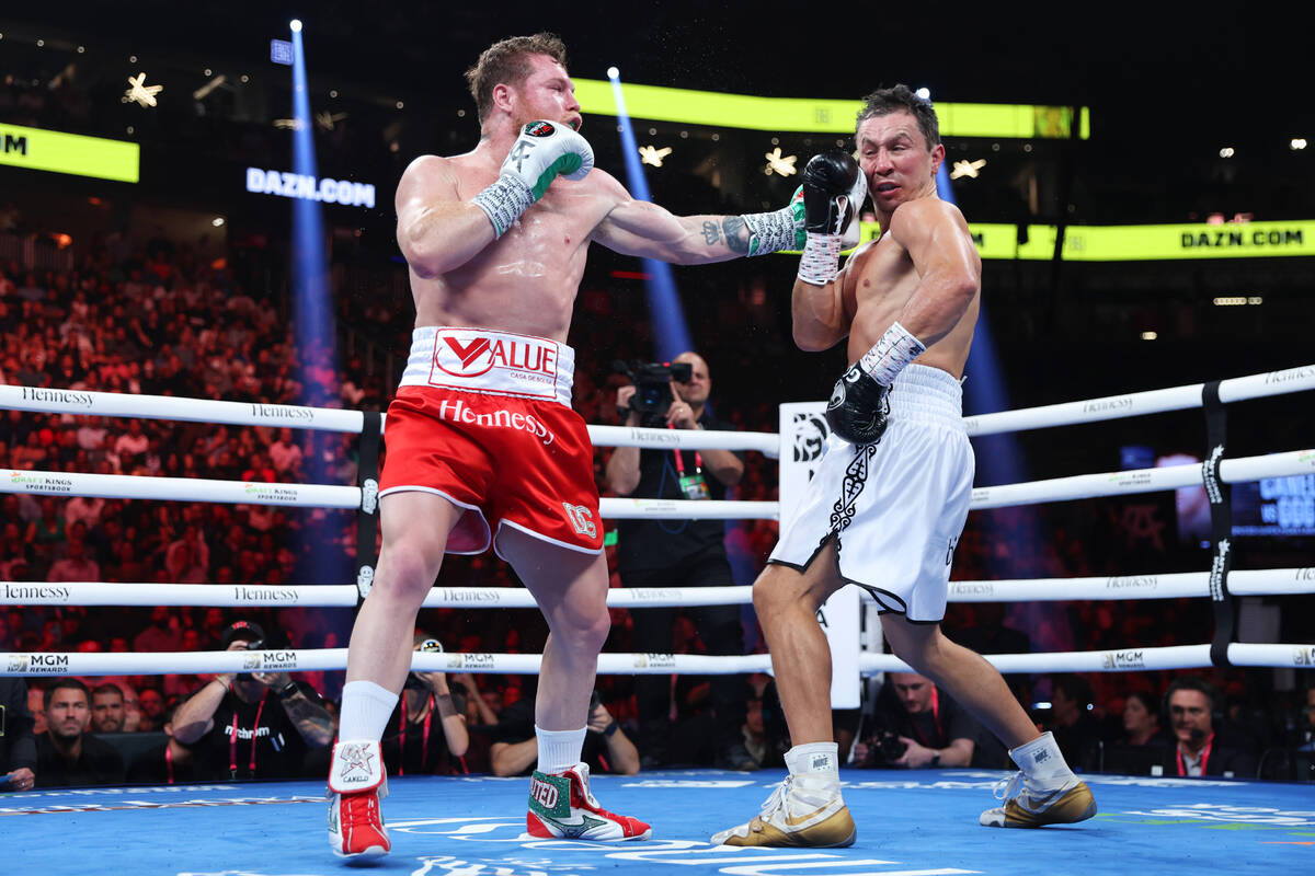 Saul "Canelo" Alvarez, left, lands a much against Gennadiy "GGG" Golovkn, i ...