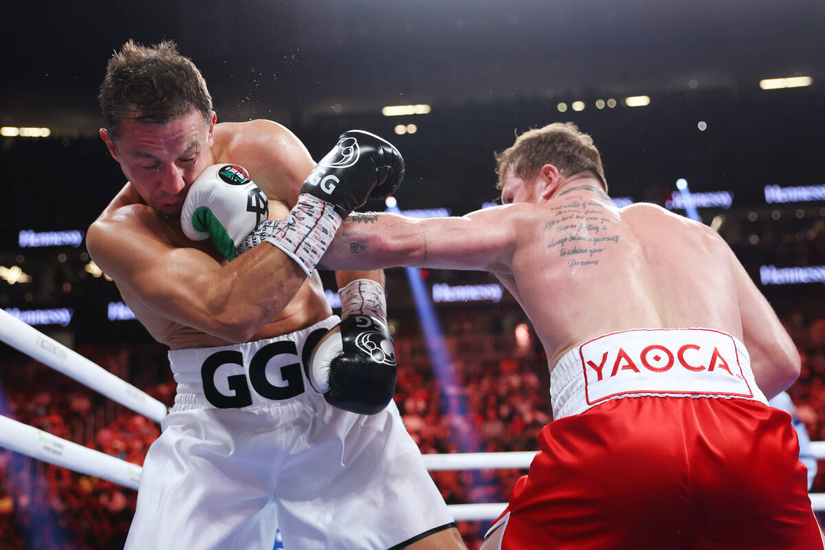 Gennadiy "GGG" Golovkin, left, takes a punch from Saul "Canelo" Alvarez, in ...