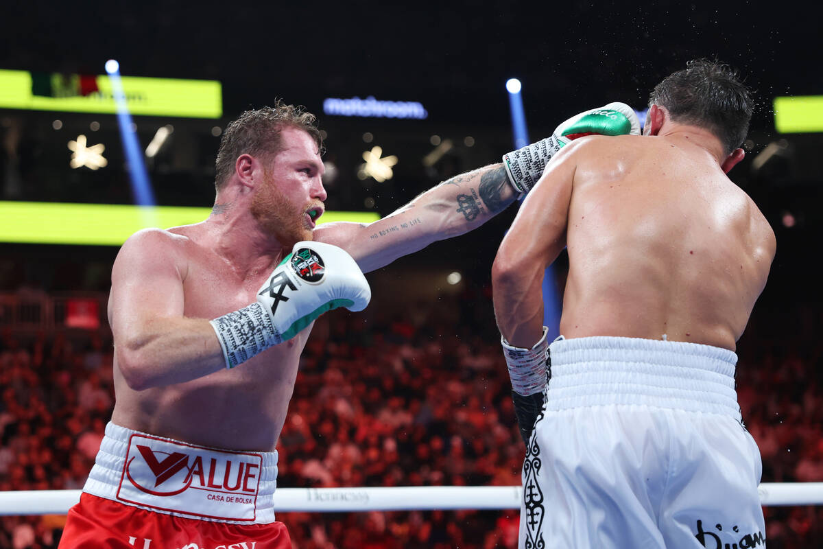 Saul "Canelo" Alvarez, left, throws a punch against Gennadiy "GGG" Golovkin ...
