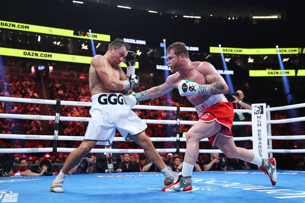 Gennadiy "GGG" Golovkin, left, defends a punch from Saul "Canelo" Alvarez, ...