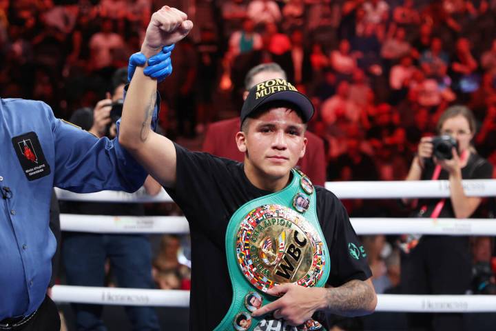 Jesse "Bam" Rodriguez, right, raises his arm in victory after his unanimous decision victory ag ...