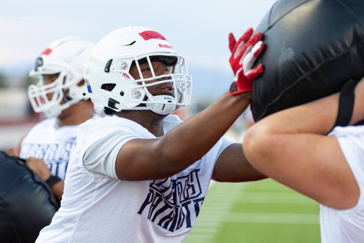 Ed Haynes runs a defensive drill during a team football practice at Liberty High School in Hend ...