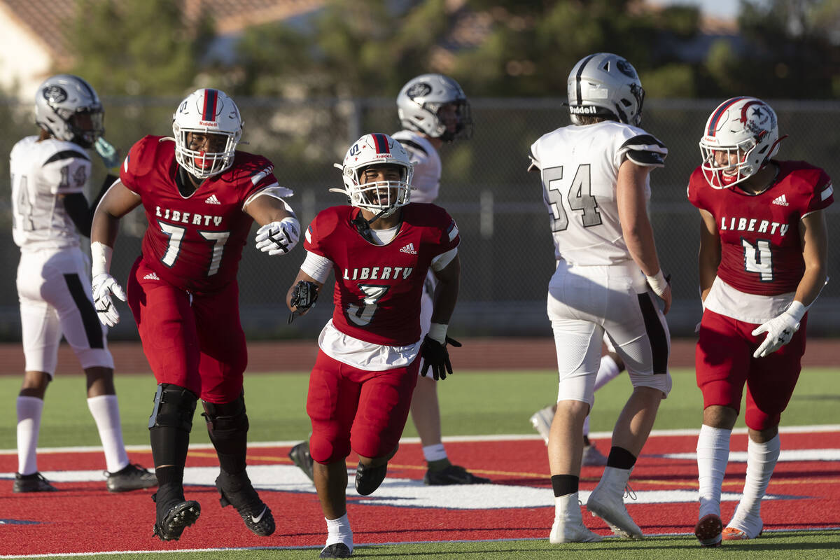 Liberty’s Ed Haynes (77), Isaiah Lauofo (3) and Colin Gregorio (4) celebrate after Lauof ...