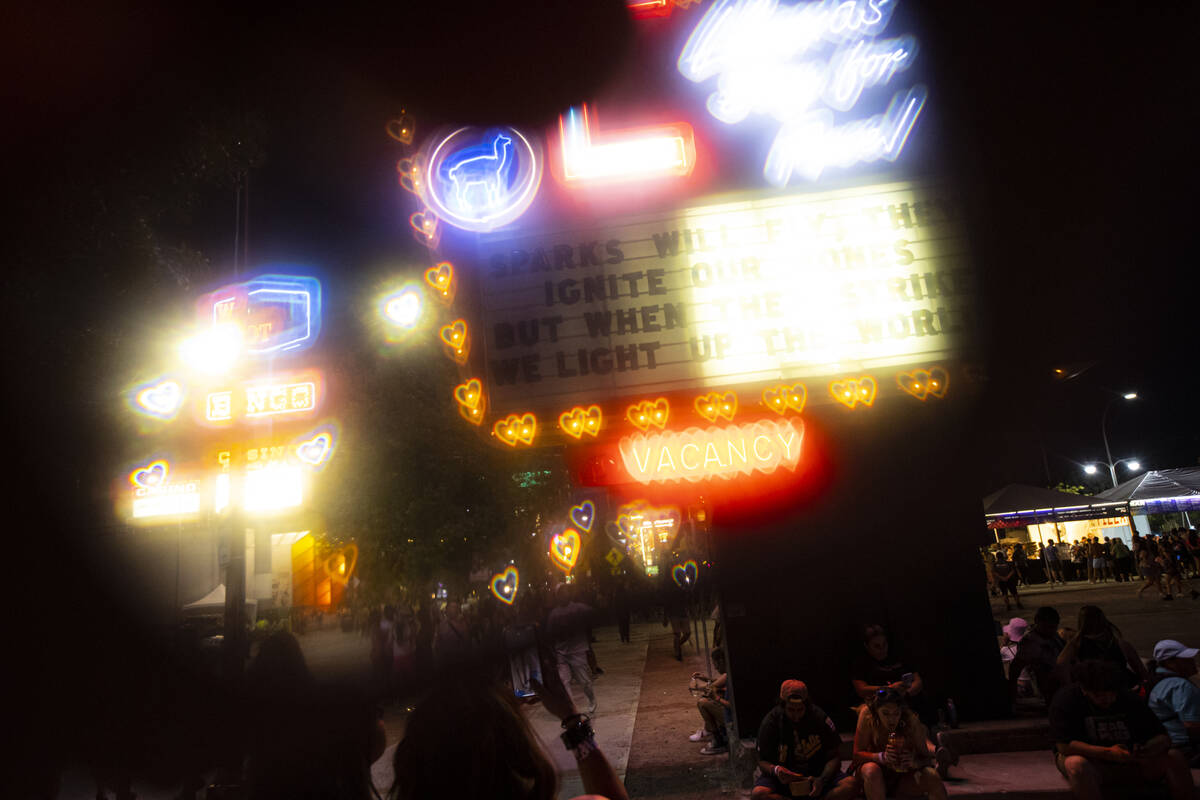 A view of neon signs through a prismatic lens during of the Life is Beautiful festival on Satur ...