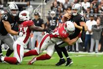 Las Vegas Raiders quarterback Derek Carr (4) is sacked by Arizona Cardinals defensive end J.J. ...