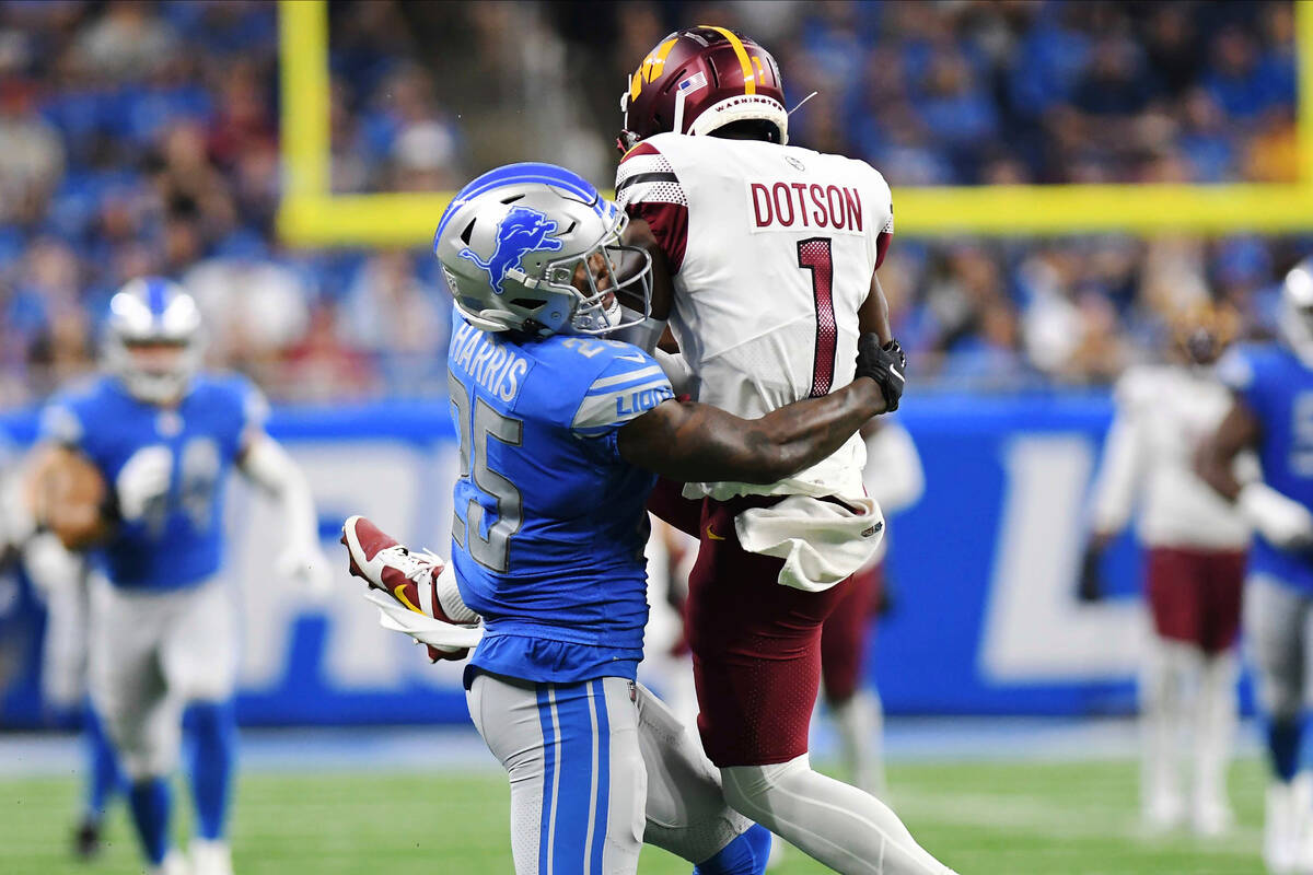 Detroit Lions safety Will Harris (25) tackles Washington Commanders wide receiver Jahan Dotson ...