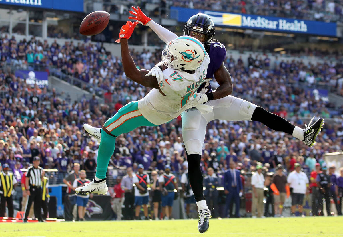 Baltimore Ravens cornerback Damarion Williams (22) breaks up a pass intended for Miami Dolphins ...