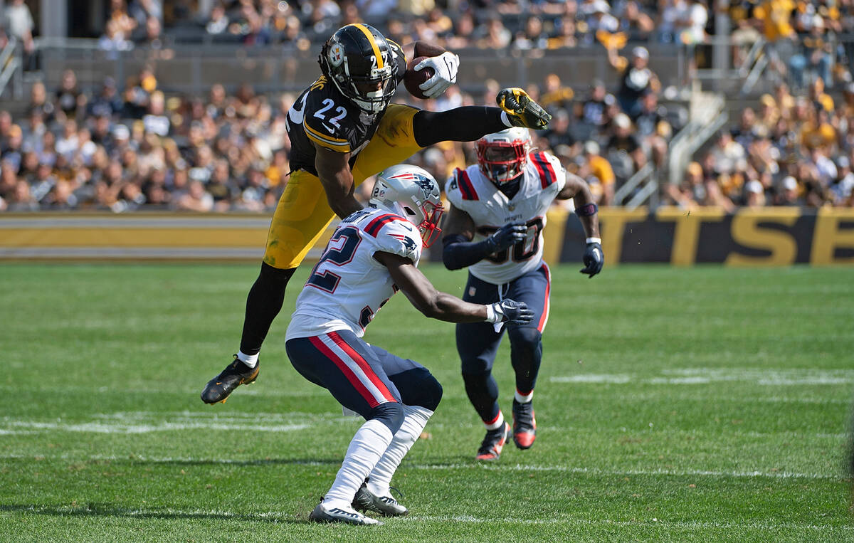 Pittsburgh Steelers running back Najee Harris (22) jumps over New England Patriots safety Devin ...