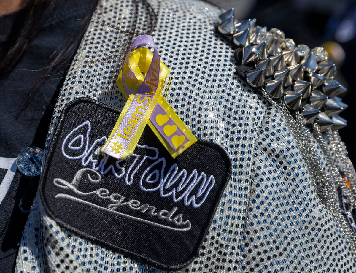 A ribbon in honor of deceased Raiders fan Sylvia Menchaca-Segura is worn by a friend during a b ...