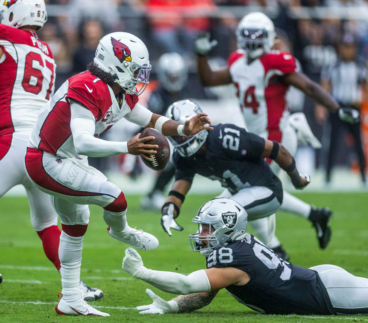 Arizona Cardinals quarterback Kyler Murray (1) is tripped up for a sack by Raiders defensive en ...