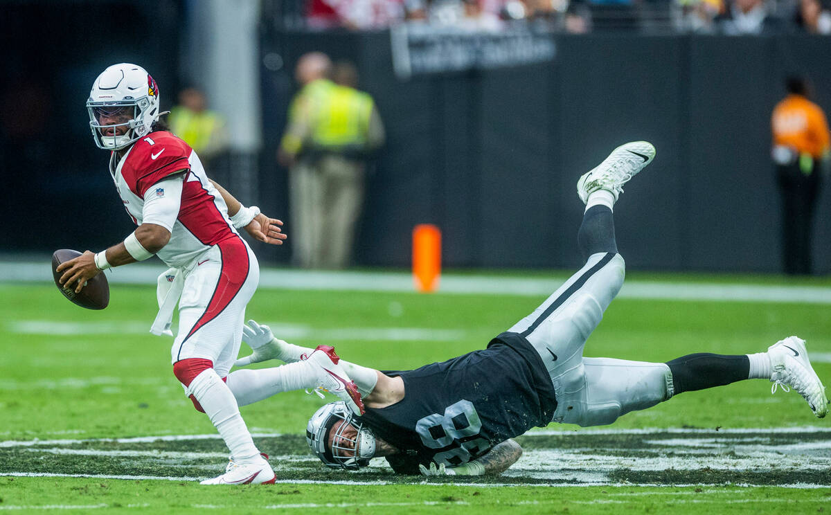 Arizona Cardinals quarterback Kyler Murray (1) evades a diving sack attempt by Raiders defensiv ...