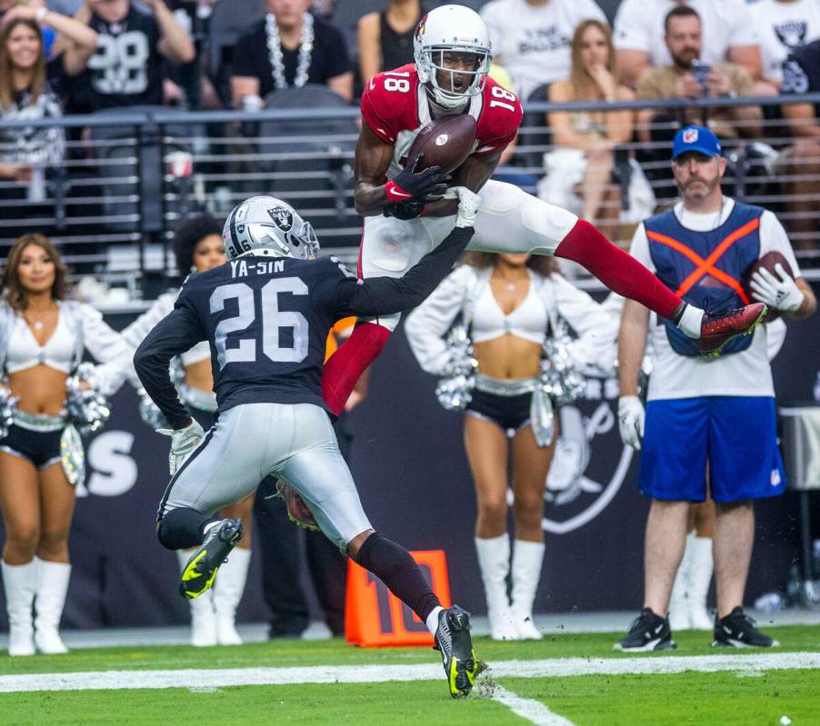 Arizona Cardinals wide receiver A.J. Green (18) attempts to secure a long pass as Raiders corne ...