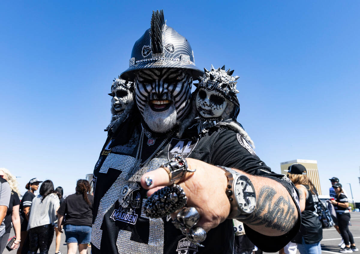 Arizona Cardinals fan Holland Raiders walks at a tailgate area out side of Allegiant Stadium pr ...