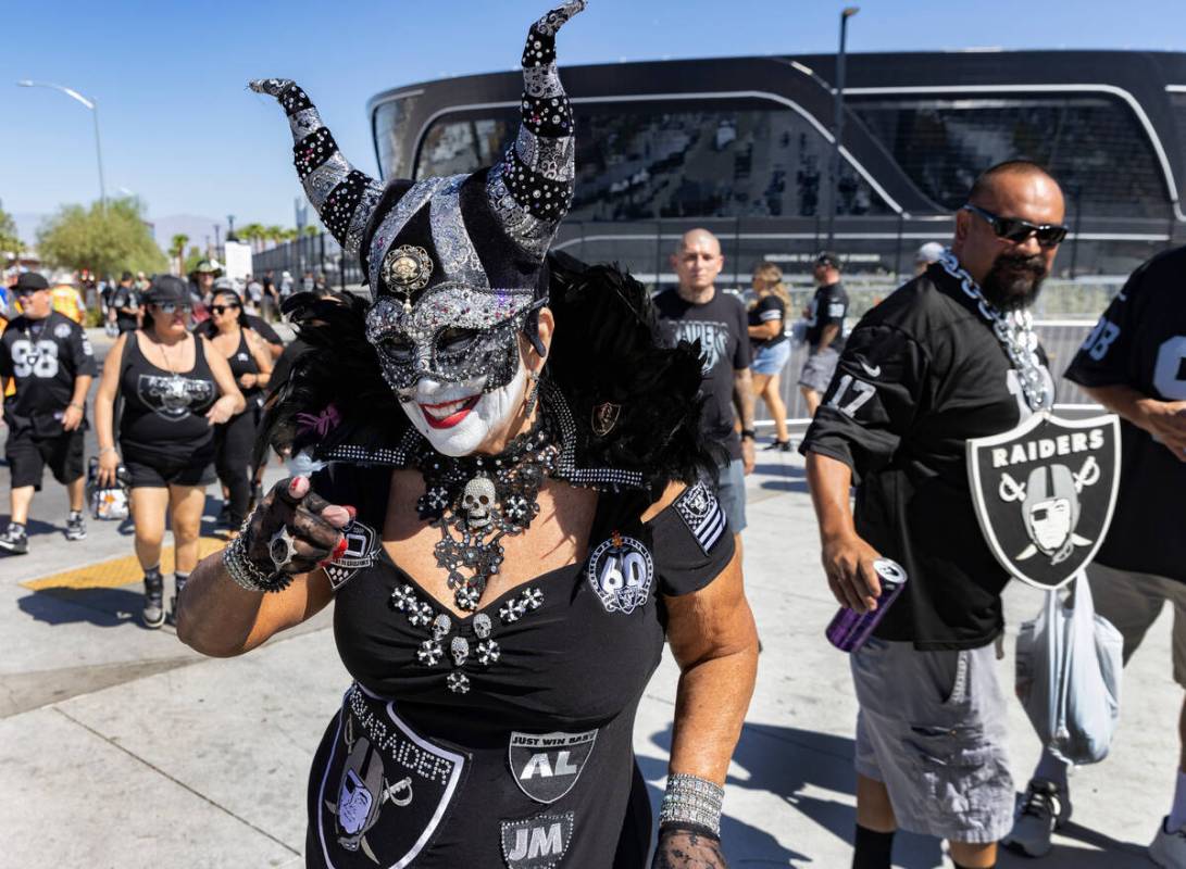 Raiders fan Pati McGaffigan "MASKARAIDER" walks at a tailgate area out side of Allegi ...